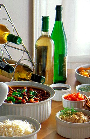 Lamb Curry and sambols with bottles of  white wine