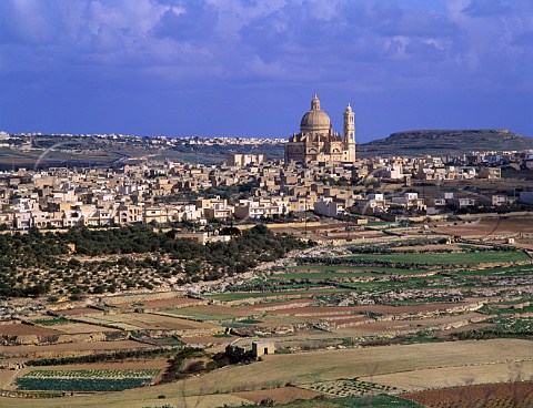 The massive church of StJohn the Baptist dwarfs the town of Xewkija Gozo Malta