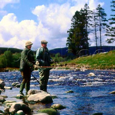 Elderly couple fishing for salmon on the   River Findhorn Scotland