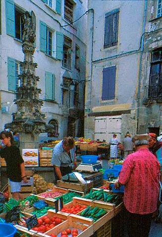 Market stalls around the fountain in   Forcalquier Alpes de HauteProvence   France