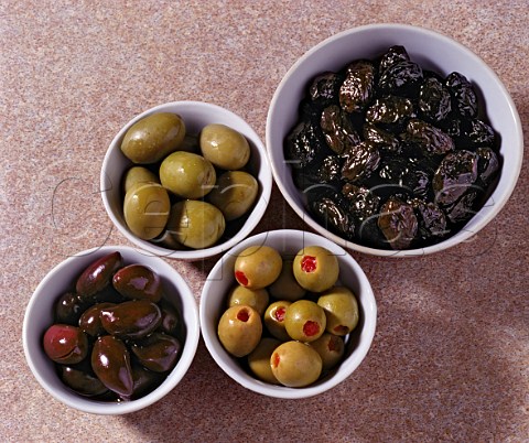Assorted olives  clockwise from bottom left    Calamata Large Green Spanish Thassos Throumbes   Spanish Green stuffed with pimento