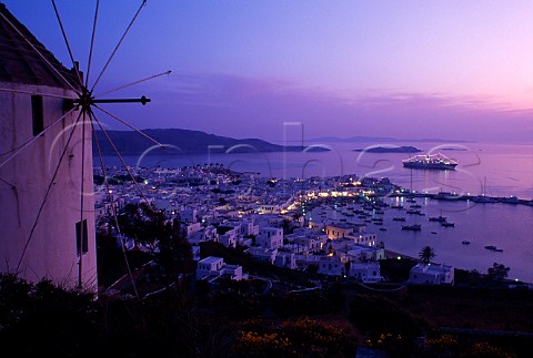 Windmill above the town and harbour at   dusk Mykonos Cyclades Islands Greece