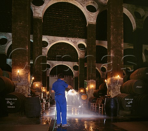Spraying water on the sand covered floor to increase humidity in the Cathedral Bodega of Antonio Barbadillo Sanlcar de Barrameda Andalucia Spain   Manzanilla  Sherry