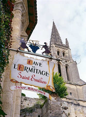 Sign on wall of the Cave de lHermitage wine shop below the belltower of the church   Stmilion Gironde France