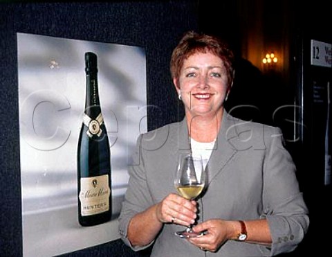 Jane Hunter with poster advertising her   Miru Miru sparkling wine  Marlborough New Zealand