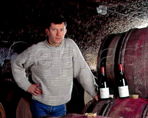 Christophe Roumier with bottles of Musigny and  RuchottesChambertin in his barrel cellar  Domaine Georges Roumier ChambolleMusigny   Cte dOr France