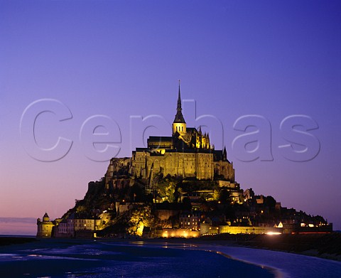 Le MontStMichel at dusk on the island of Mont   Tombe The 10thcentury Benedictine abbey   is now a national monument  Manche France   Basse Normandie
