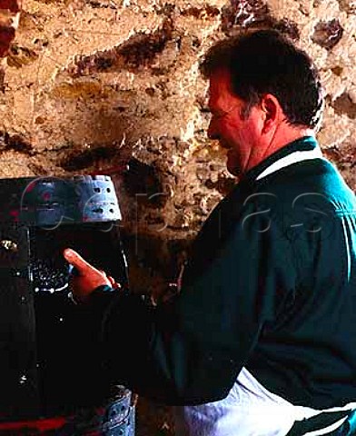 Disgorging a bottle of champagne in the cellars of   Salon Le MesnilsurOger Marne France