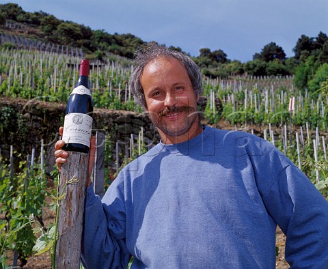 Thierry Allemand with a bottle of his Cornas Le Renard in the Syrah vineyard of the same name Cornas Ardche France   AC Cornas