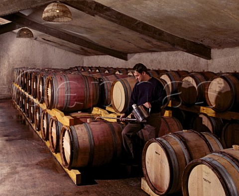 Christophe Sabon topping up barrels ouillage in chai of Domaine de la Janasse Courthzon Vaucluse France  ChteauneufduPape