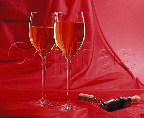 Two glasses of white wine with corkscrew