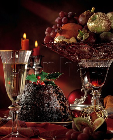 Christmas Christmas pudding with a bowl of fruit and glasses of wine