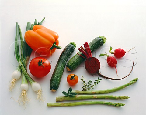 Assorted vegetables Spring onions orange bell pepper tomatoes courgettes beetroot radishes  thyme sage asparagus