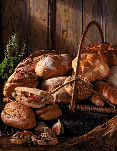 Bread Assorted breads with Prosciutto ham and fig  filled bread olive cheese and fig crostini and  green olive and fish crostini