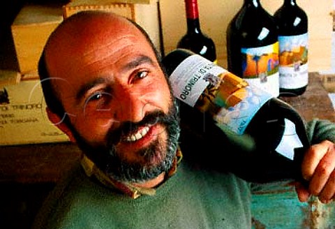 Stefano Piccio oenologist with   bottle of his Rosso di Toscana   Tenuta di Trinoro Sarteano Tuscany   Italy   Colli Senesi