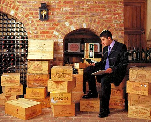 Vincent Gasnier cataloguing wines in a   clients cellar