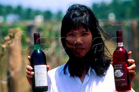 Woman with bottles of wine in vineyard   of Allied Domecq north of Saigon   Vietnam
