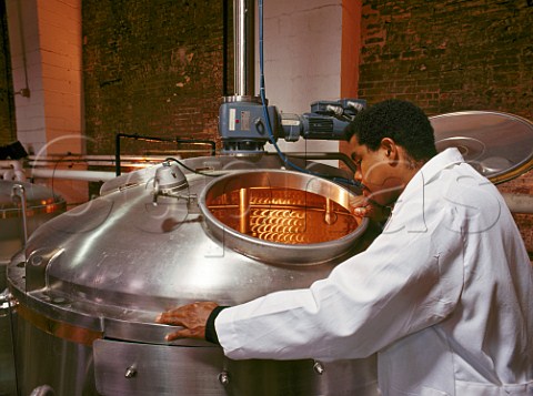 Brewmaster Garrett Oliver inspects one of his three   brew kettles Brooklyn Brewery New York USA