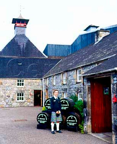 Tour guide at entrance to the visitor centre of   Glenfiddich whisky distillery Dufftown Banffshire   Scotland Speyside