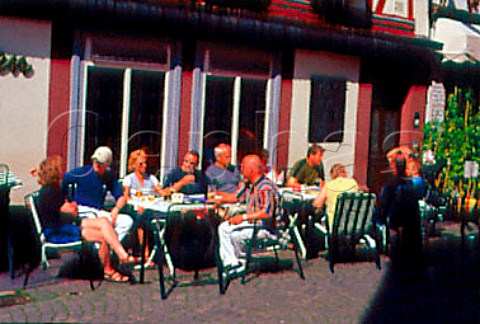 People drinking Bitburger beer outside  the Bitchen bar Bernkastel Mosel Valley Germany