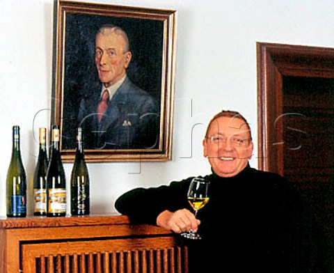 Raimund Prm winemaker  owner of Weingut SAPrm   next to a portrait of the winerys founder Sebastian Alois Prm Wehlen Germany    Mosel
