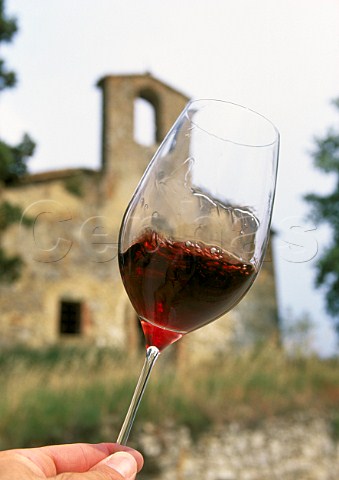 Swirling a glass of glass of Castello della Sala Pinot Nero in village of Sala Umbria Italy  
