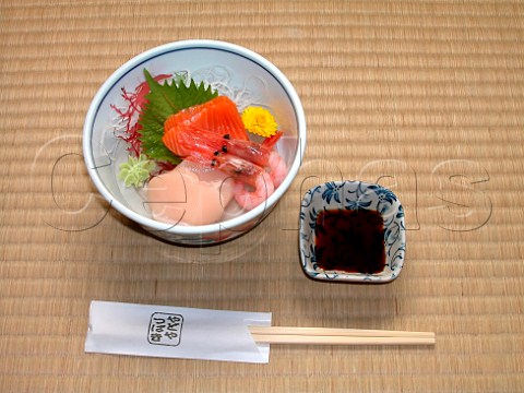 Japanese Sashimi slices of raw fish or seafood on a  bed of shredded daikon radish