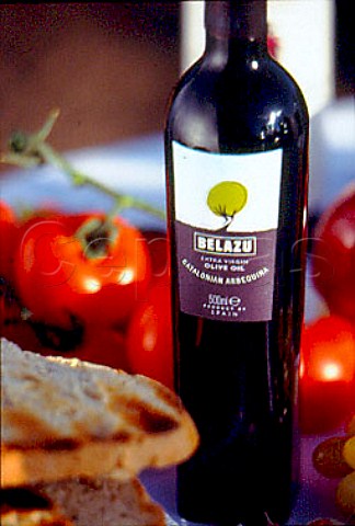 Bottle of Belazu Catalonian Olive Oil  with bread and tomatoes