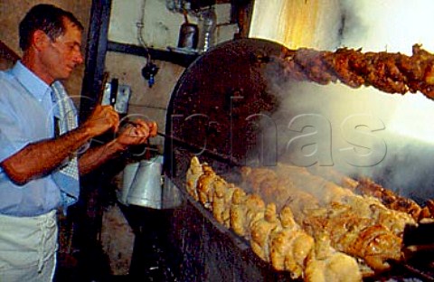 Cooking chickens on a spit   Restaurant Bonjaidim Lisbon Portugal