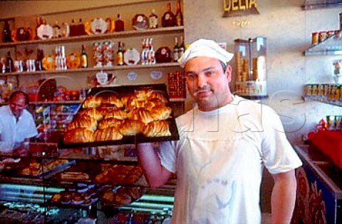 Chef holding tray of croissants   Lisbon Portugal