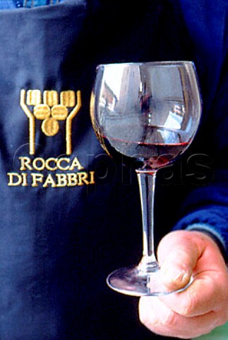 Worker holding glass of Rocca di Fabbri    red wine Fabbri near Montefalco   Umbria Italy