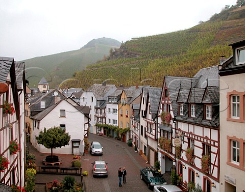 Main street in Bernkastel overlooked by Schlossberg   vineyard with Doctor vineyard behind Mosel Germany