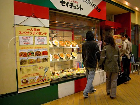 Customers outside a pizza restaurant on the top   floor of a Tokyo department store  Japan