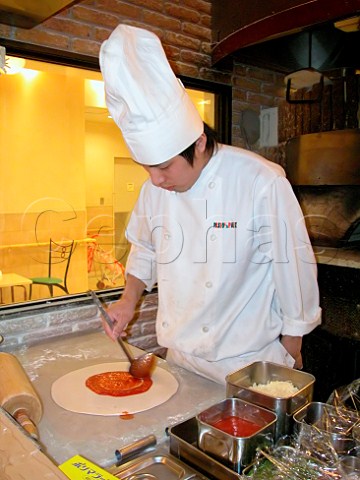 Chef preparing a pizza in an Italian style   restaurant  Tokyo Japan