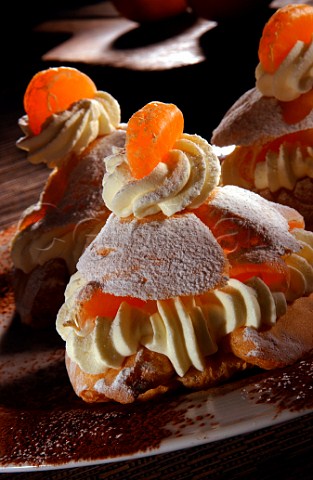 Choux pastry bun filled with cream and tangerine segments