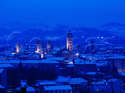 Dusk falls over the snowcovered town of Alba   Piemonte Italy