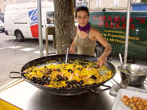 Preparing paella in a giant frying pan at Blaye  market Gironde France Aquitaine