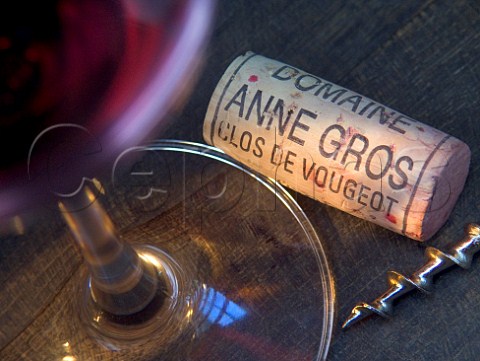Glass of red wine with corkscrew and  Domaine Anne   Gros cork