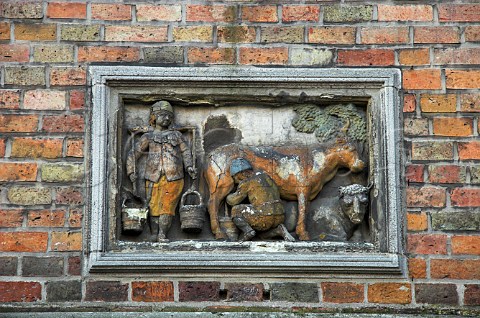 Small carving depicting milking time in the tanners   square huidenvetters next to Steenhouwers canal   Brugge Belgium