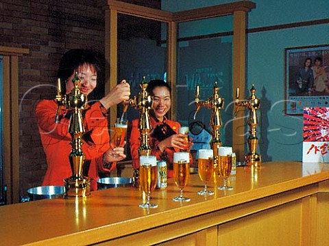 Pouring Malts beer in the hospitality room at   Suntorys Musashino brewery Tokyo