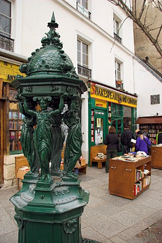 Wallace drinking fountain dating from 1840 in front   of the Shakespeare and Company bookshop Paris   France