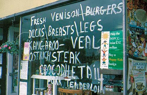 Butchers window advertising exotic   meats Bingley West Yorkshire England