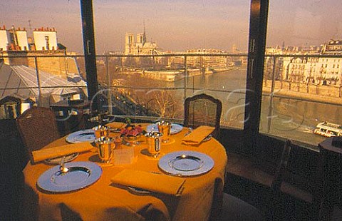 Table setting La Tour DArgent   restaurant with view of Notre Dame   Cathedral and river Seine Paris France