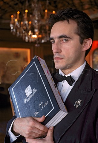 Sommelier Stephane Trapier holding the   wine list at La Tour DArgent   restaurant Paris France