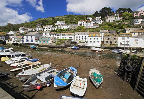 Boats in Polperro harbour at low tide Cornwall   England