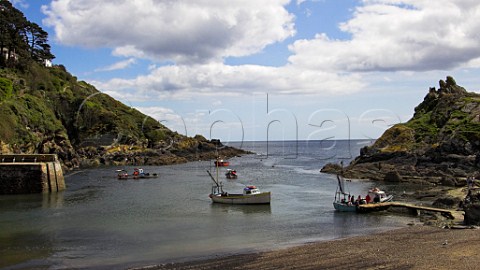 Small boats at the entrance to Polperro harbour   Cornwall England