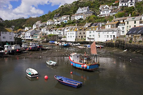 Boats in Polperro harbour at low tide Cornwall   England