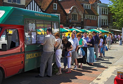 Long queue at an icecream van in Salisbury market  in June Wiltshire England