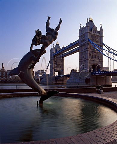 Dolphin and girl fountain with Tower Bridge behind   London England