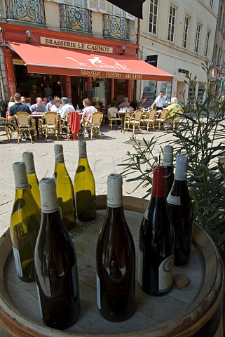 Brasserie Le Carnot in central Beaune viewed through display of Burgundy wine bottles CtedOr Burgundy France